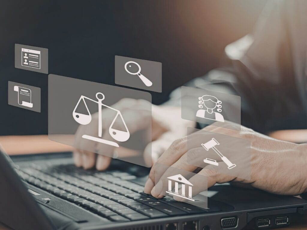 Hands typing on a laptop with floating legal-themed icons, including scales of justice, a gavel, a courthouse, and a magnifying glass, symbolizing Digital Forensics Basics in the modern legal landscape.