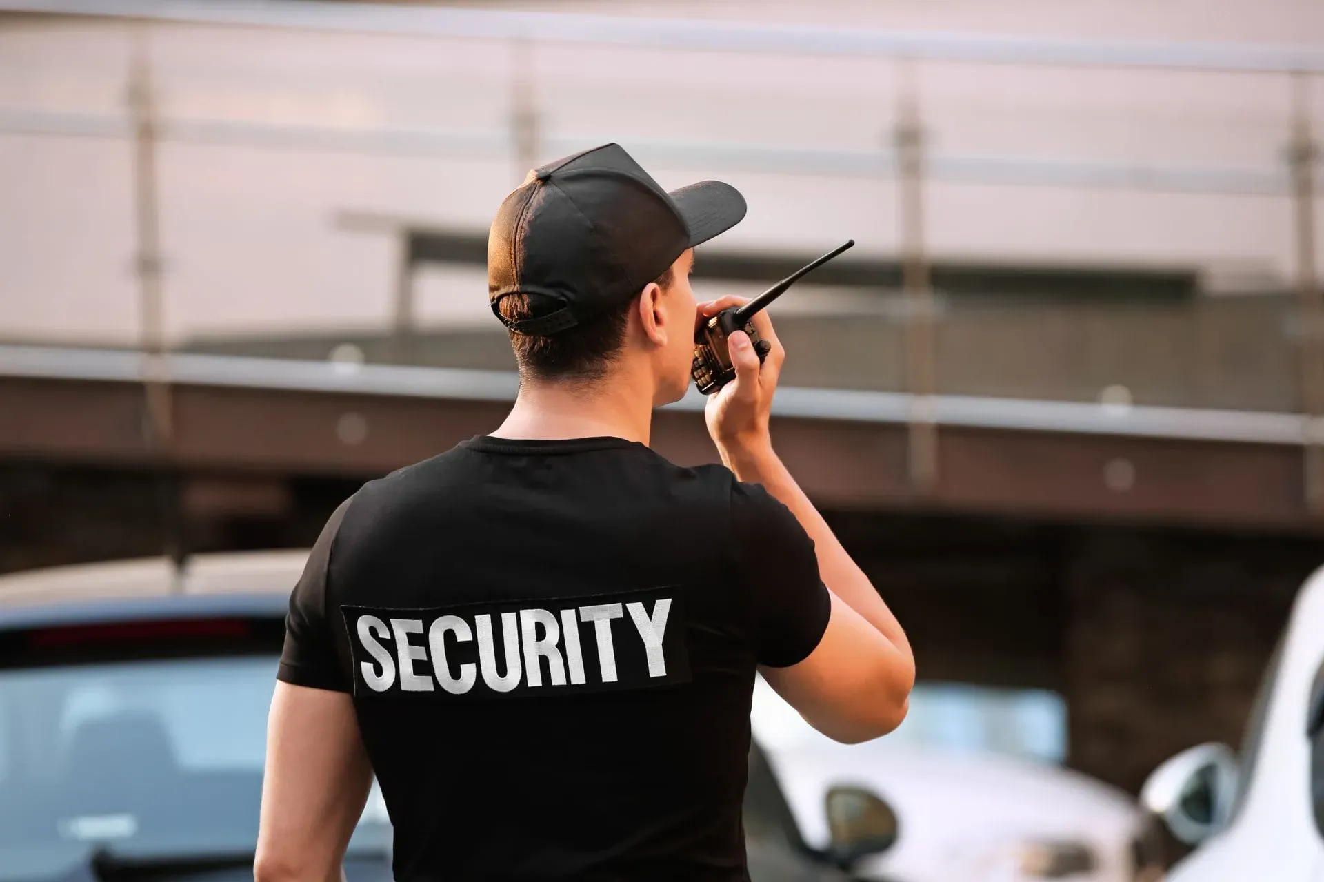 Security personnel communicating via radio in a parking lot